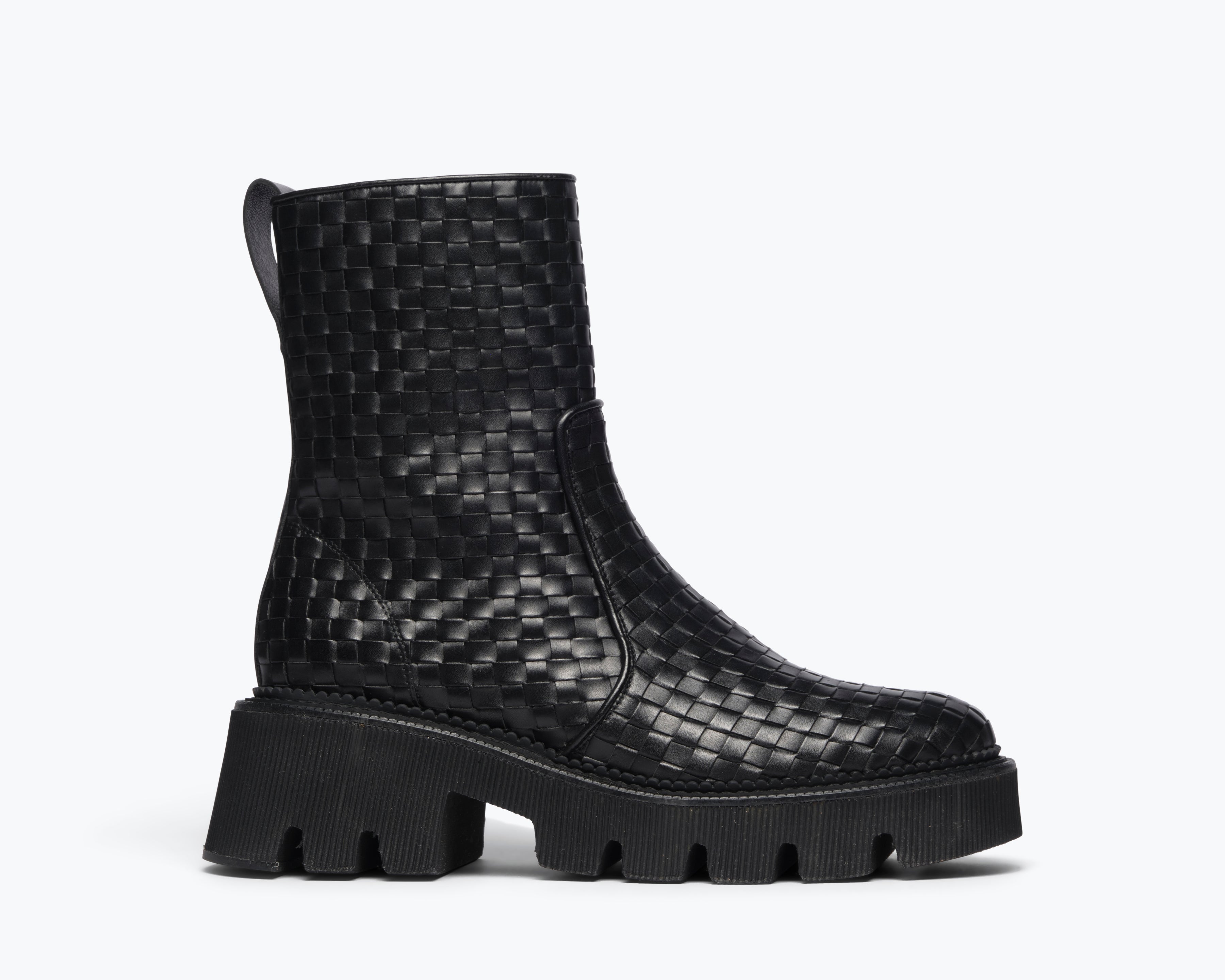 Black woven Chelsea boot by Freda Salvador featuring a sleek silhouette and elastic side panels, front view.