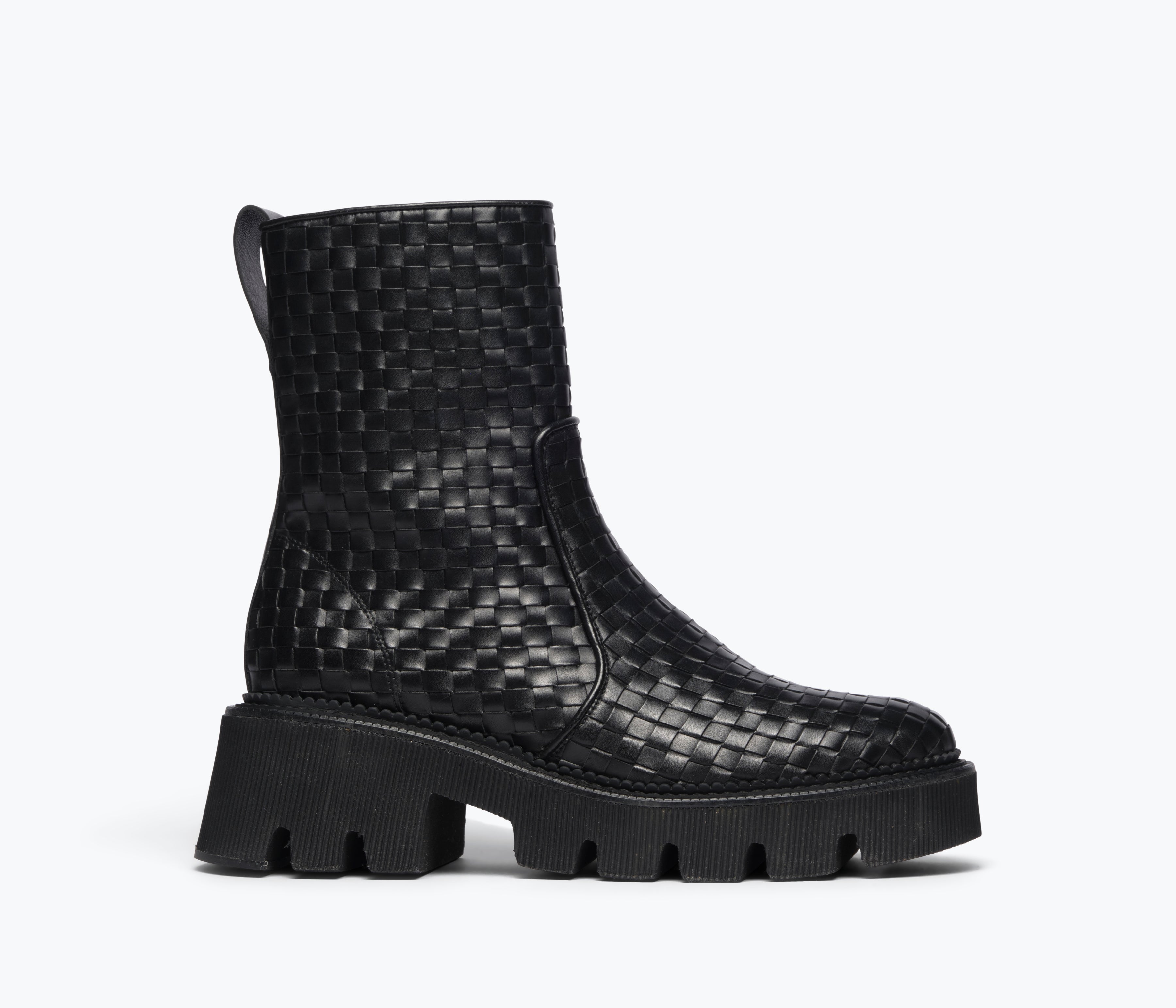 Black woven Chelsea boot by Freda Salvador featuring a sleek silhouette and elastic side panels, front view.