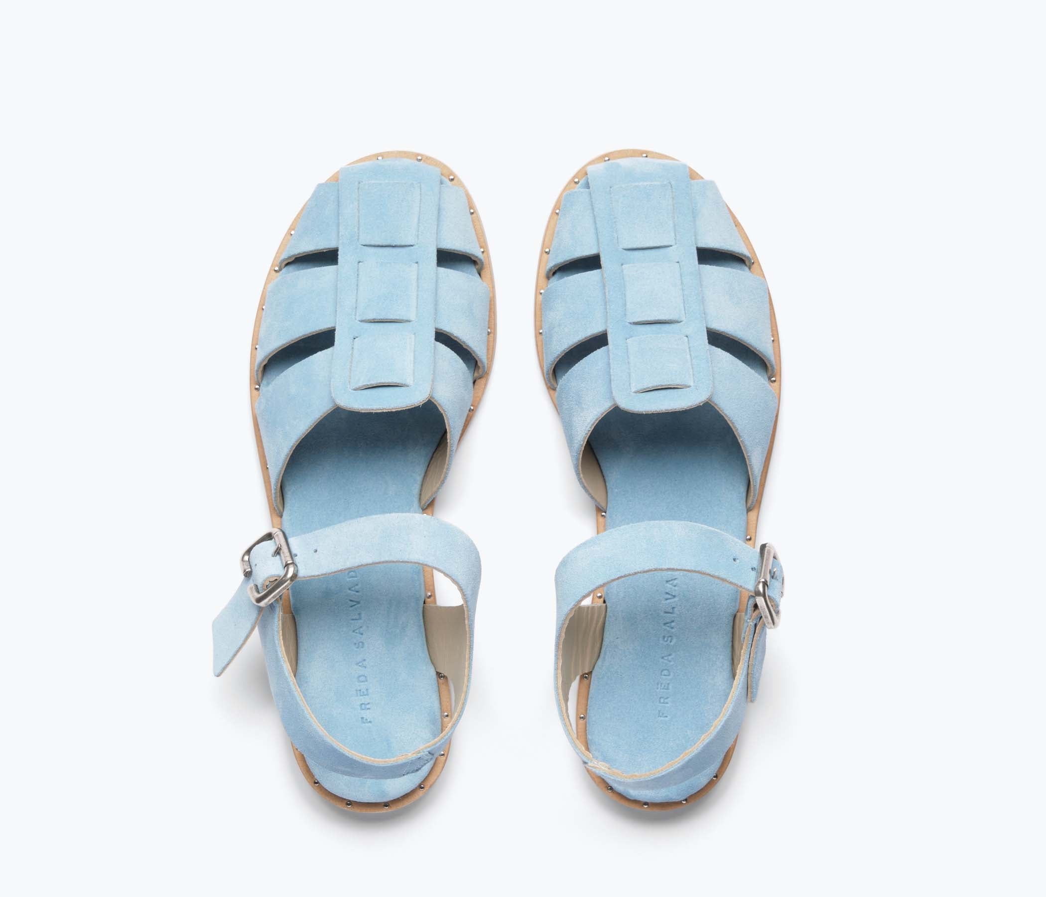 Blue suede Sera fisherman sandal by Freda Salvador featuring a strappy design and open toe.