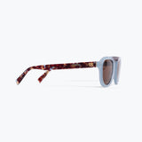 Sunglasses with tortoiseshell frame and light blue lenses on a white background
