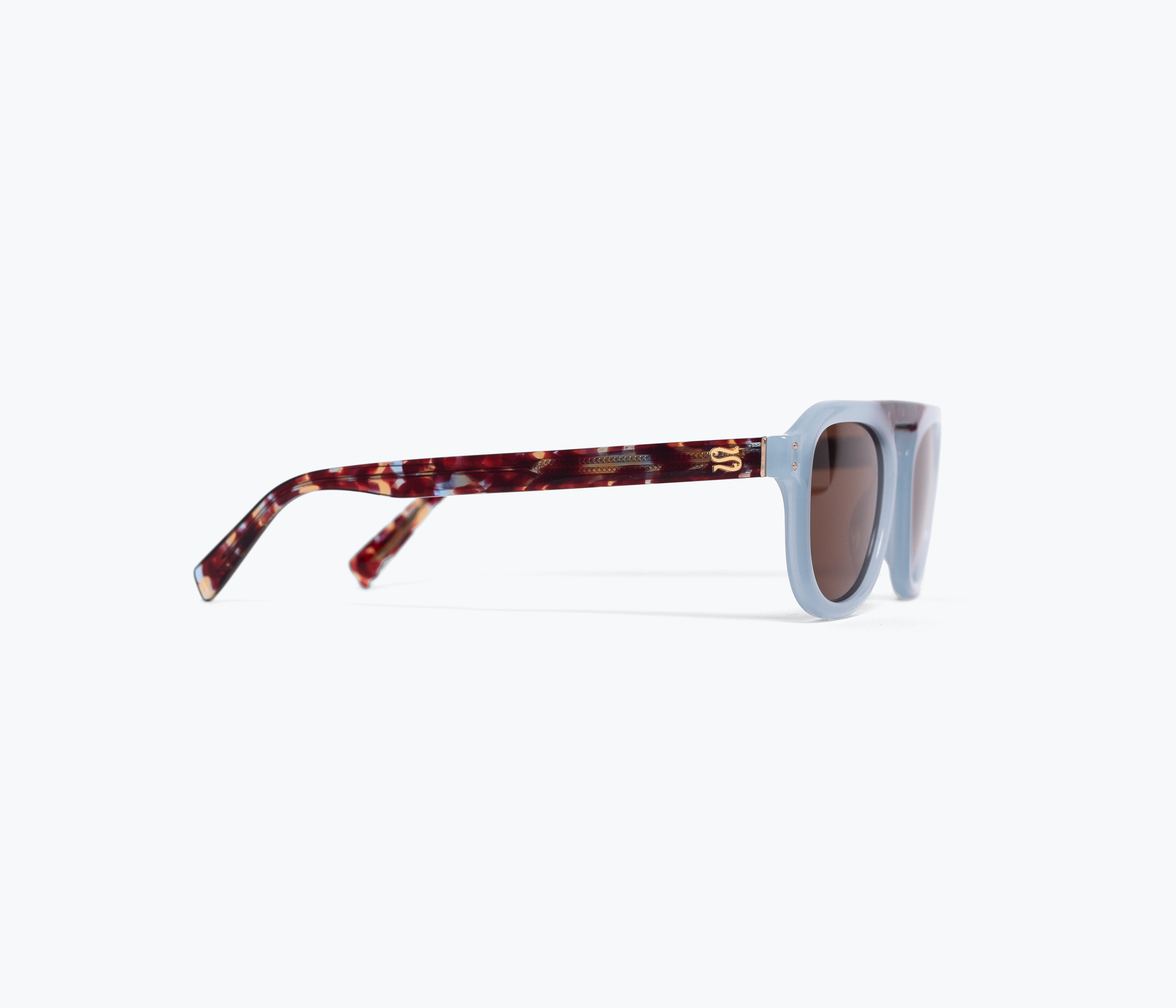 Sunglasses with tortoiseshell frame and light blue lenses on a white background