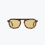 Sunglasses with tortoiseshell frame and gold lenses on a white background