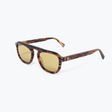 Sunglasses with tortoiseshell frame and gold lenses on a white background