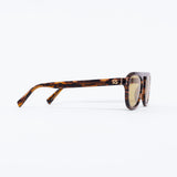 Sunglasses with tortoiseshell frame and gold lenses on a white background