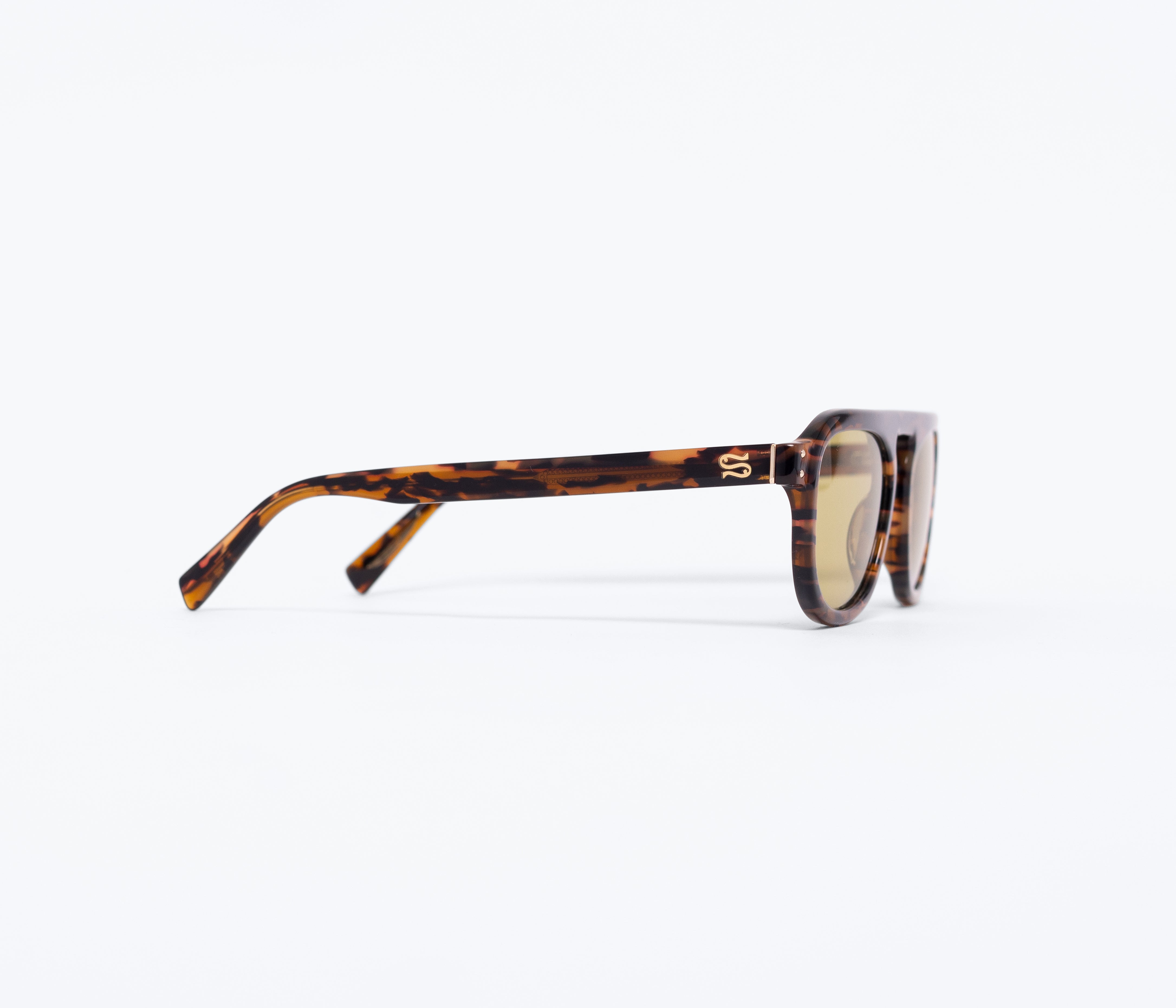 Sunglasses with tortoiseshell frame and gold lenses on a white background