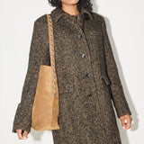 Brown FREDA SALVADOR CALA studded tote bag with sleek design and silver-tone hardware, featuring multiple compartments and sturdy handles.