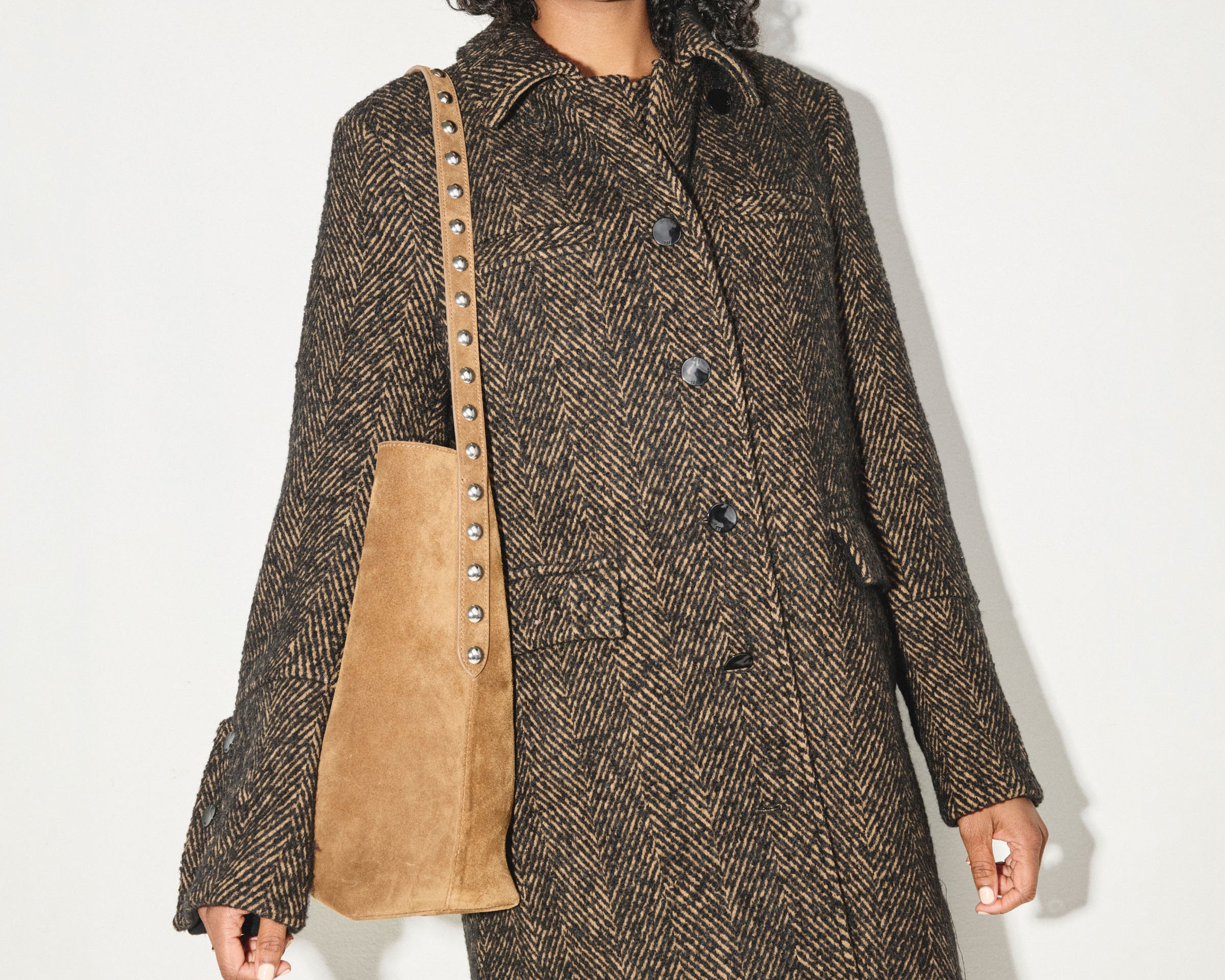 Brown FREDA SALVADOR CALA studded tote bag with sleek design and silver-tone hardware, featuring multiple compartments and sturdy handles.