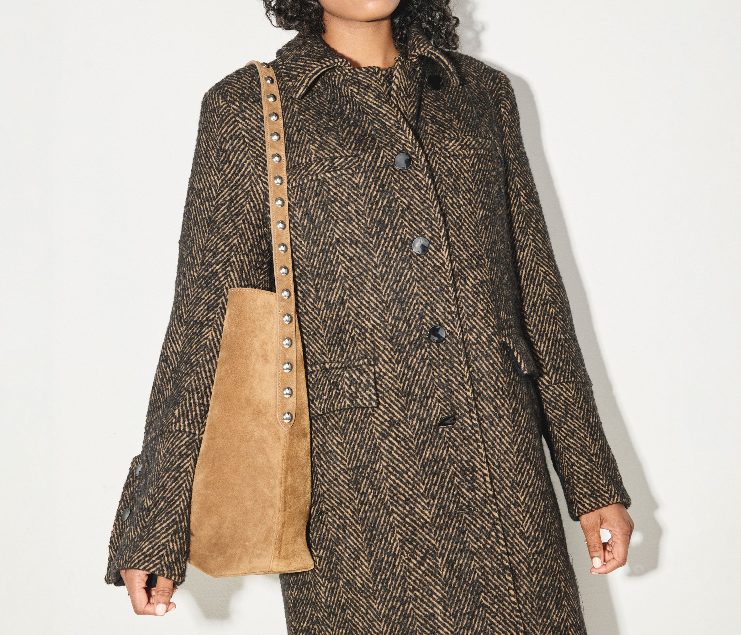 Brown FREDA SALVADOR CALA studded tote bag with sleek design and silver-tone hardware, featuring multiple compartments and sturdy handles.