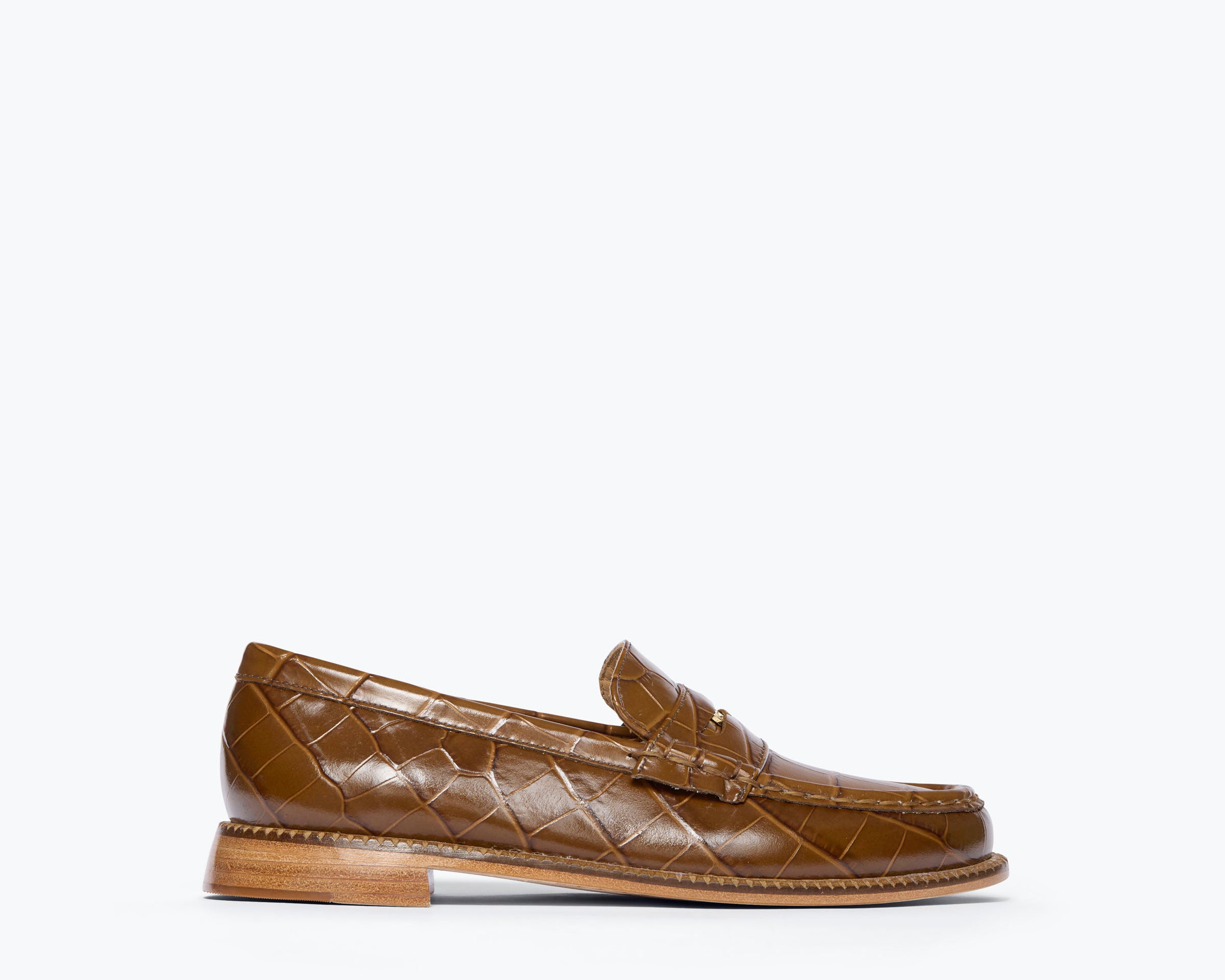 A single brown crocodile-embossed leather penny loafer shown in profile against a clean white background.