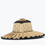 Beige straw hat with black trim on a white background