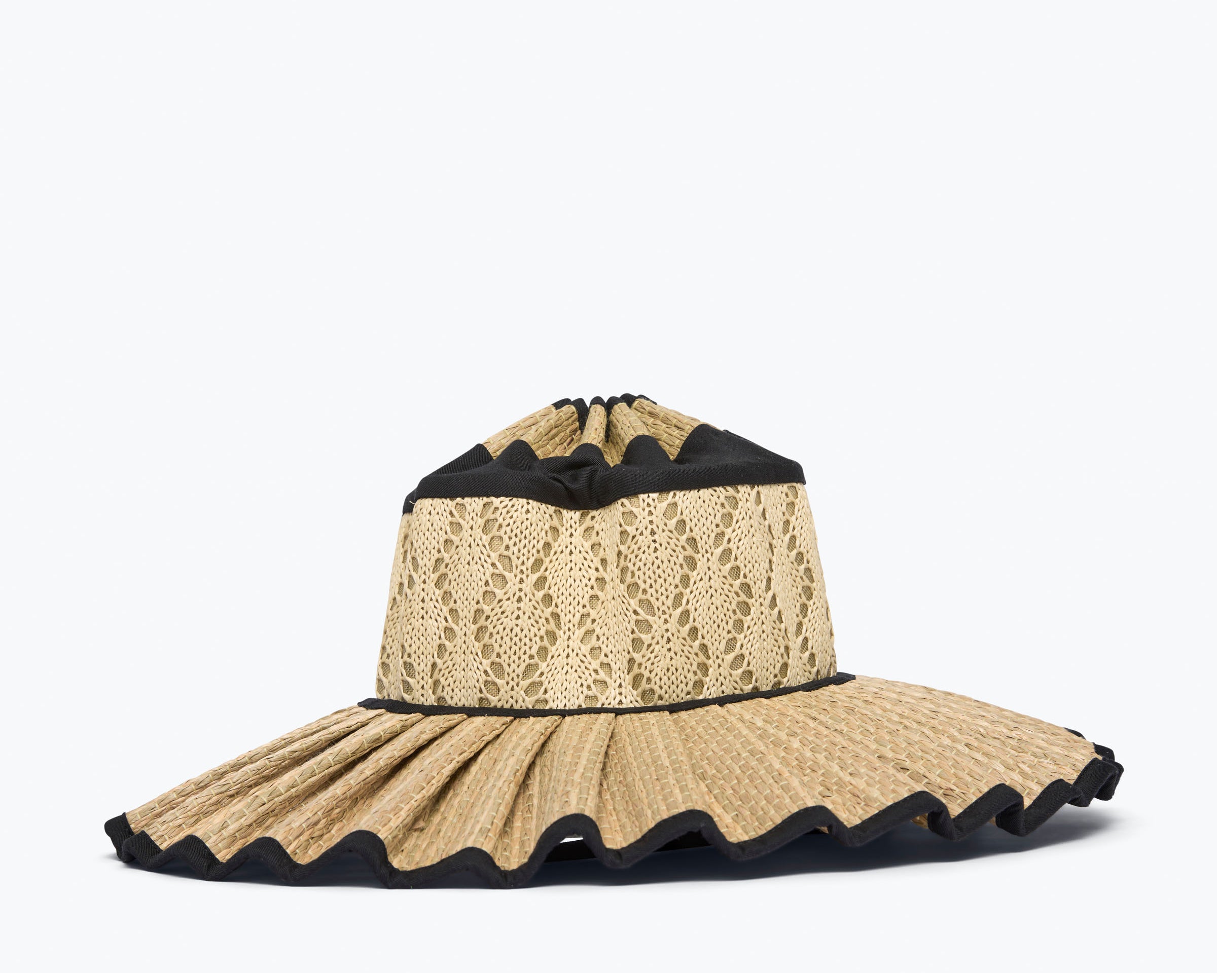 Beige straw hat with black trim on a white background