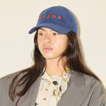 Embroidered Freda Hat in navy corduroy, on figure
