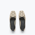 Pair of beige lace-up shoes on a white background