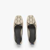 Pair of beige lace-up shoes on a white background