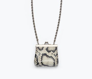 Black snake-patterned mini purse necklace by Freda Salvador, featuring a compact bag design with a sleek chain necklace.