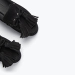 Black suede Freda Salvador Leon Tassel Penny Loafer Mule with tassel details and slip-on style.