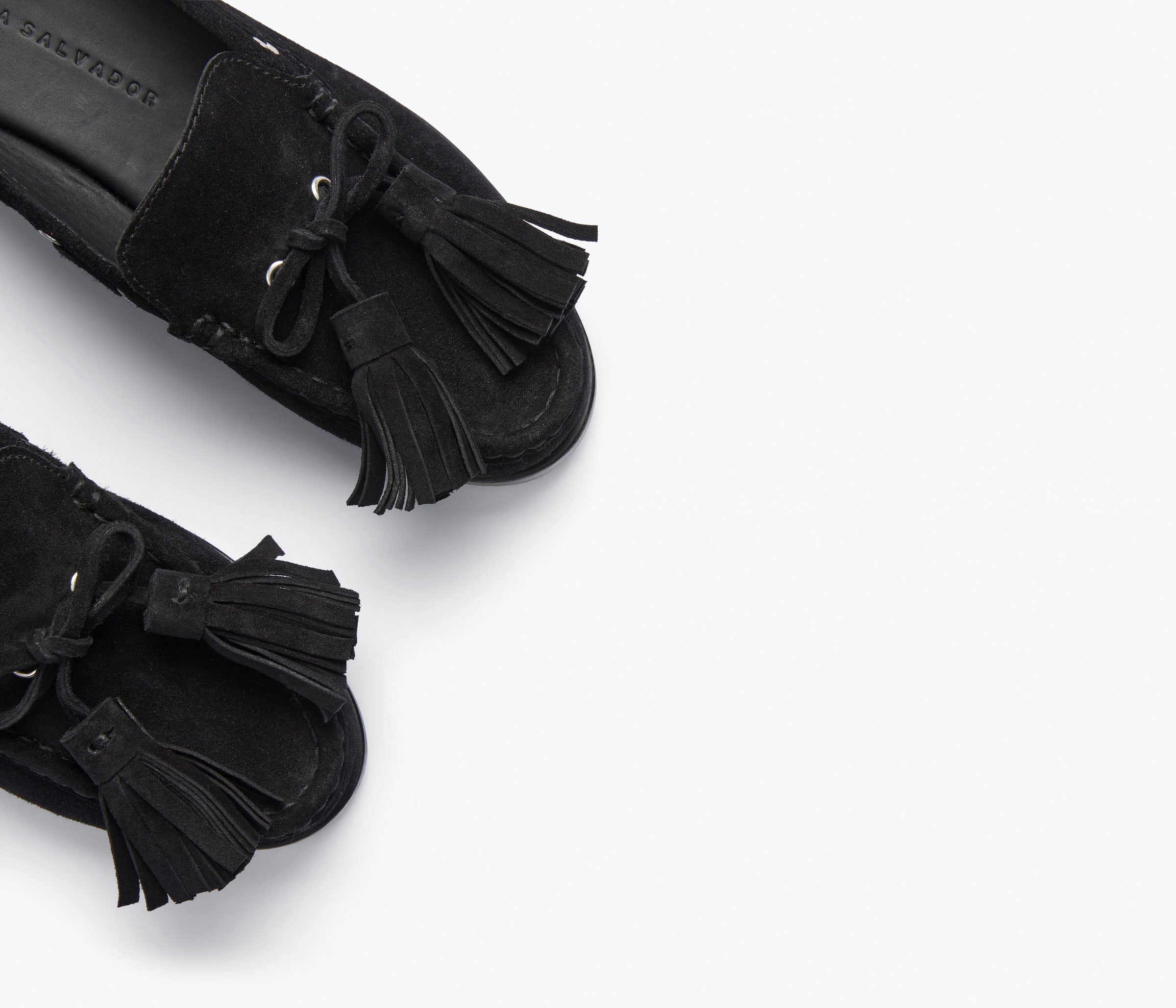 Black suede Freda Salvador Leon Tassel Penny Loafer Mule with tassel details and slip-on style.