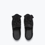 Black suede LEON tassel penny loafer mule by Freda Salvador with a sleek, minimalist slip-on design and tassel detail.
