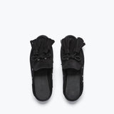 Black suede LEON tassel penny loafer mule by Freda Salvador with a sleek, minimalist slip-on design and tassel detail.