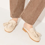 Freda Salvador Leon Tassel Penny Loafer Mule in Sahara suede featuring tassel detail and slip-on mule design.