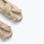 Freda Salvador Leon Tassel Penny Loafer Mule in Sahara suede featuring a slip-on design and decorative tassels on the front.