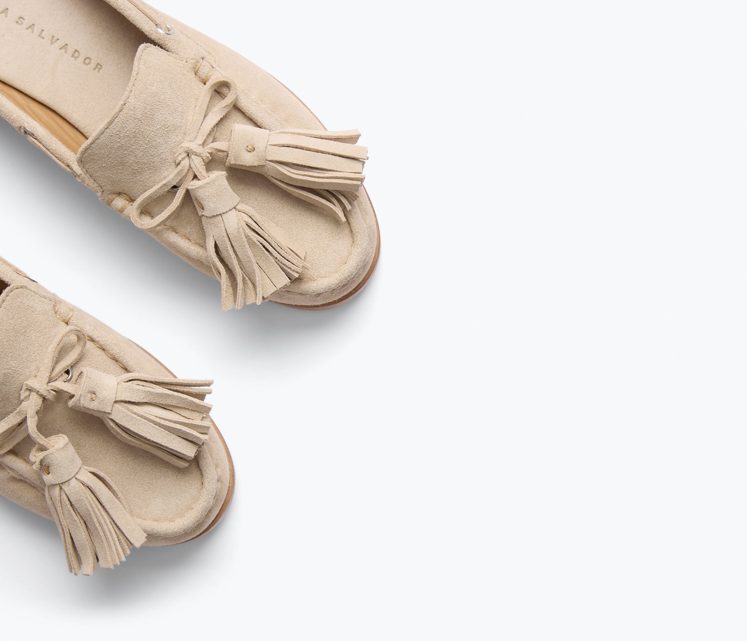 Freda Salvador Leon Tassel Penny Loafer Mule in Sahara suede featuring a slip-on design and decorative tassels on the front.