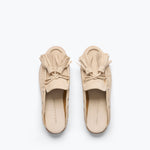 Freda Salvador Leon Tassel Penny Loafer Mule in Sahara suede with tassel details and slip-on design on a neutral background.