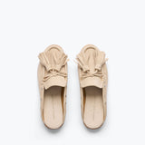Freda Salvador Leon Tassel Penny Loafer Mule in Sahara suede with tassel details and slip-on design on a neutral background.