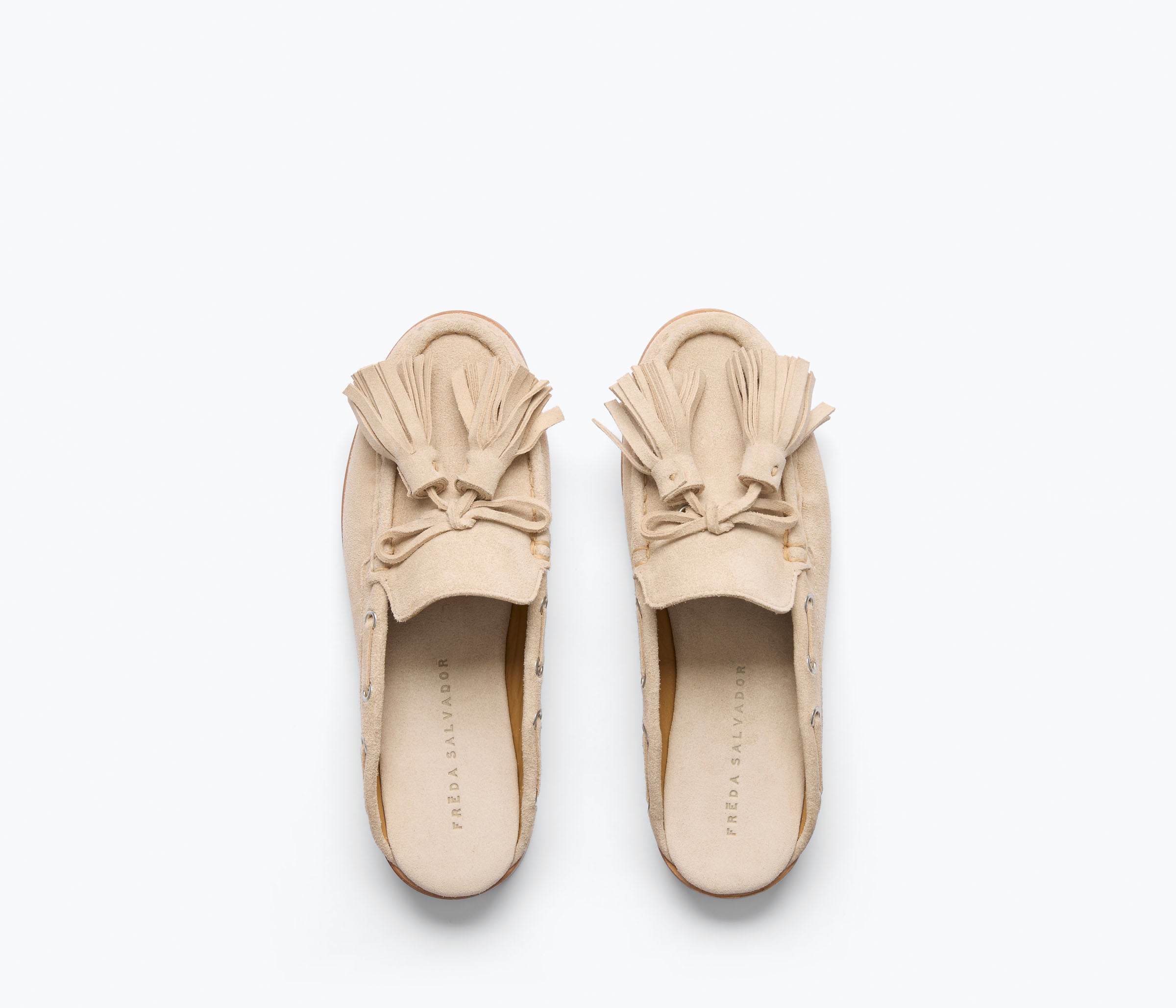 Freda Salvador Leon Tassel Penny Loafer Mule in Sahara suede with tassel details and slip-on design on a neutral background.