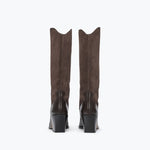 A pair of tall brown suede boots with black block heels, shown from the back against a plain white background.