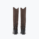 A pair of tall brown suede boots with black block heels, shown from the back against a plain white background.