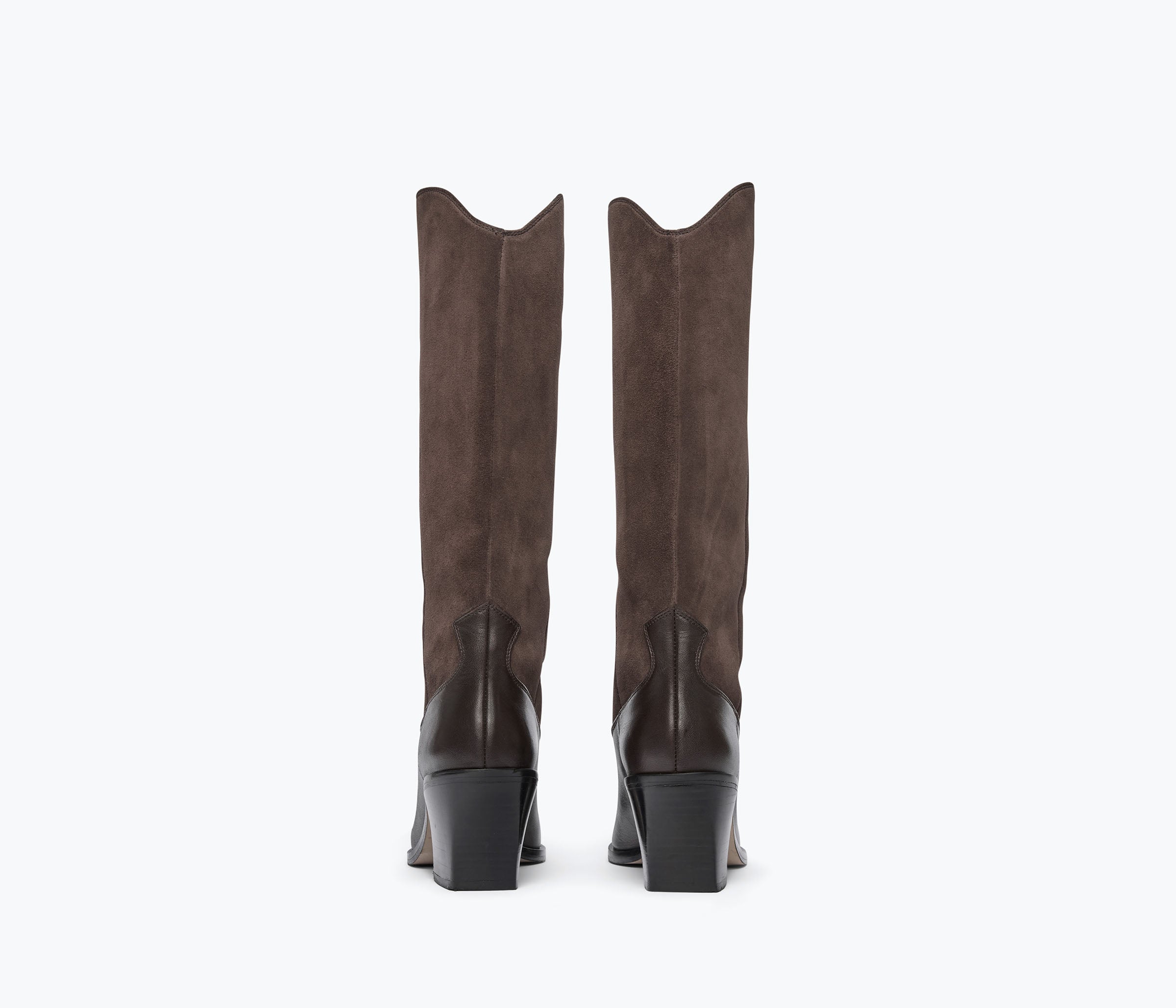 A pair of tall brown suede boots with black block heels, shown from the back against a plain white background.