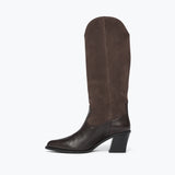 A single knee-high boot in dark brown, featuring a smooth leather lower section and a suede-like upper shaft, shown from a side profile on a light gray background.