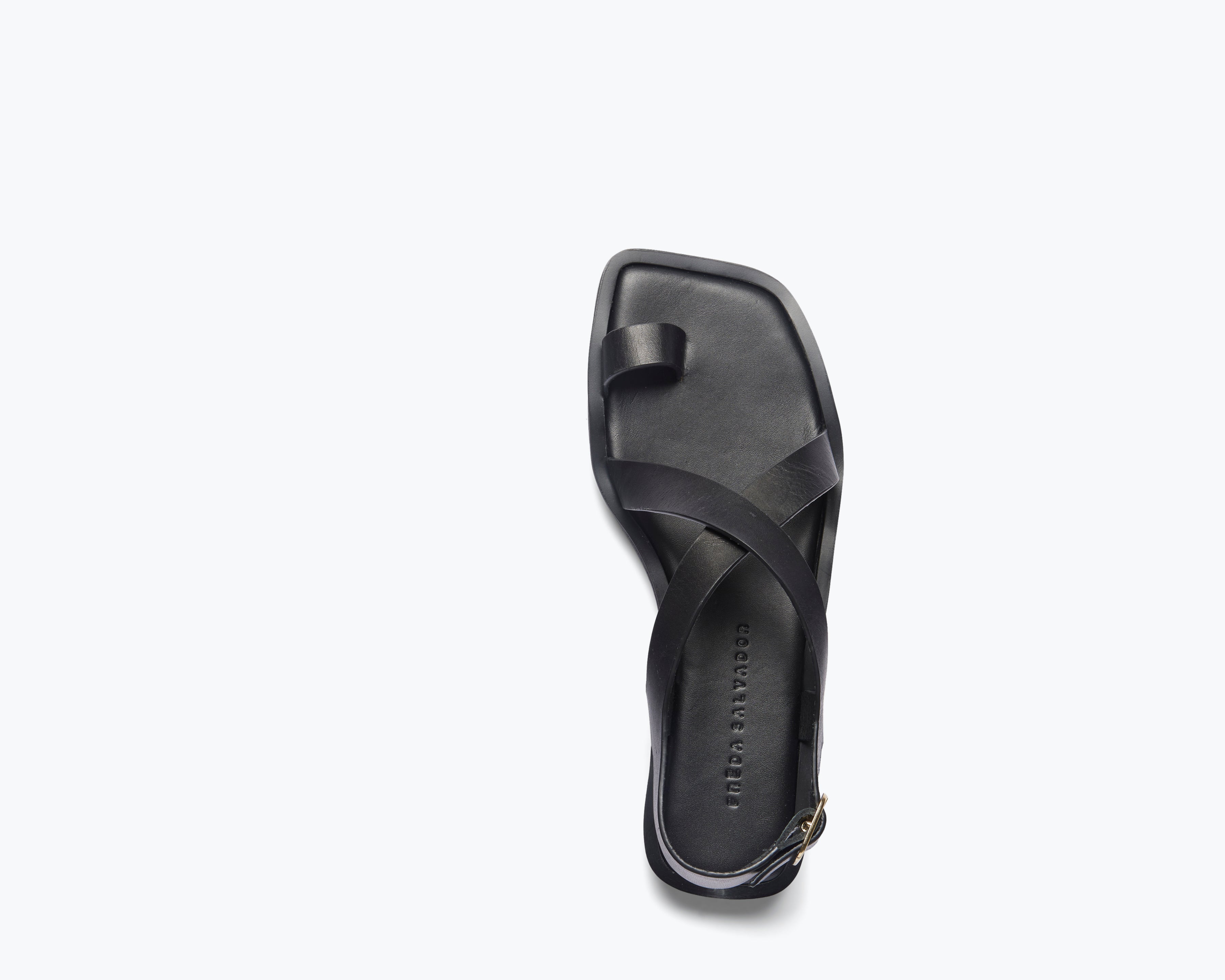 Black PAXTON sandal by FREDA SALVADOR featuring a sleek strap design and open toe style.