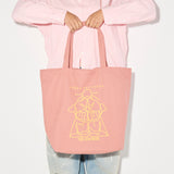 Limited edition illustrated tote bag by Freda Salvador in dusty rose with artistic design, perfect for carrying marketing materials.