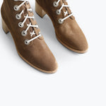 Black ACE lace-up boots by FRĒDA SALVADOR with sturdy soles and stylish design, shown from front view.