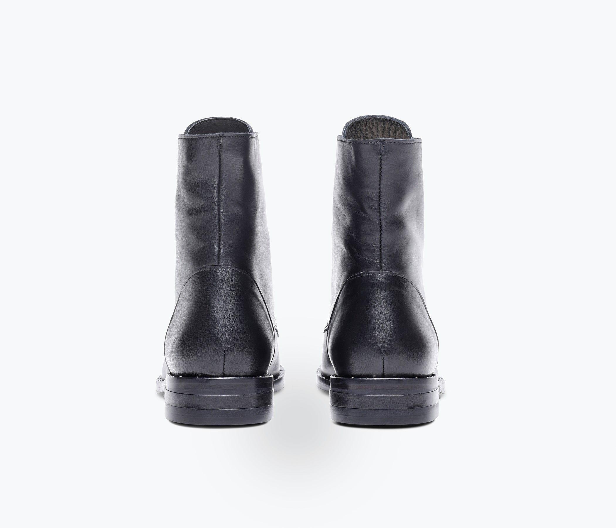 Freda Salvador Ralf lace-up boot featuring smooth leather, rounded toe, chunky heel, and stylish design on a neutral background.