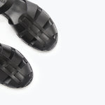 Black SERA Fisherman Sandal by FREDA SALVADOR featuring a woven strap design and open toe style.